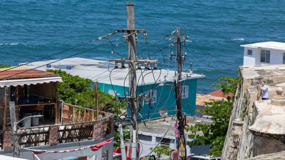 Power lines and utility poles stand in front of La Perla neighborhood along the coast in Old San Juan, Puerto Rico.