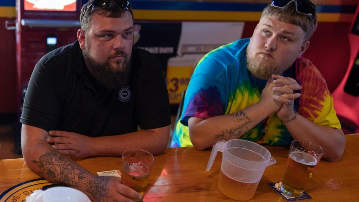 UAW Local 402 members Chaz Graham, left, and Kyle Bos, right, share a beer at Fricker's restaurant and bar in Springfield, Ohio, on Wednesday, Sept. 30, 2026.