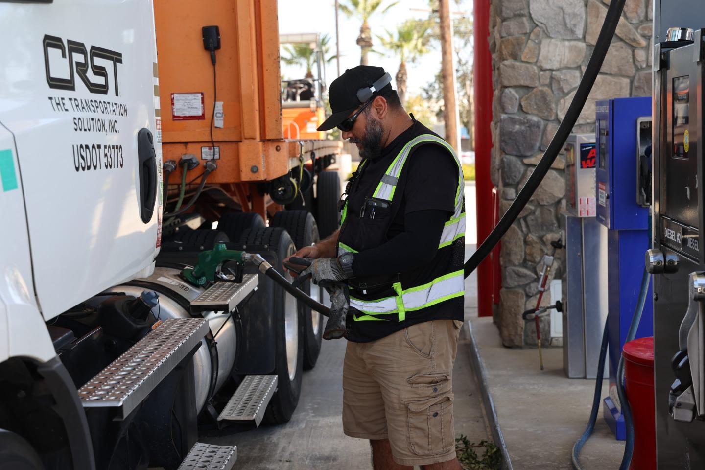 A driver filled up his truck at a gas station.